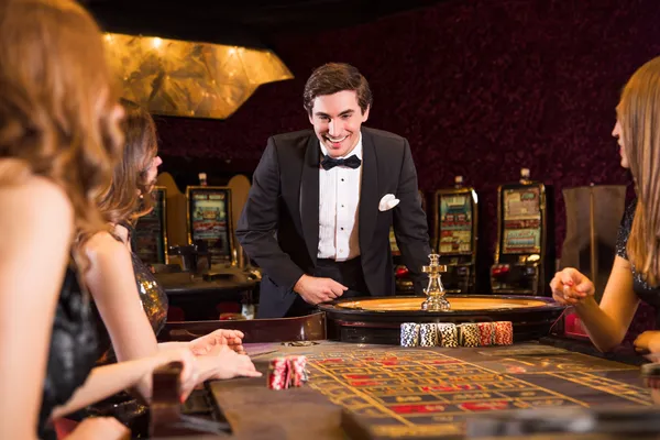 A stylish woman beside vibrant slot machines displaying glowing sevens, showcasing the variety of top slots at BDKO.